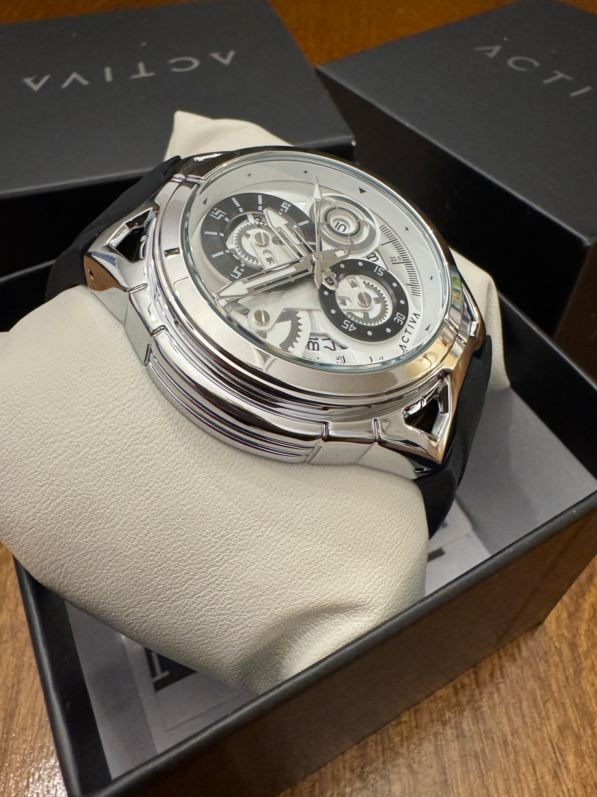 Luxury watch on a white cushion with 'Activa' branding in the background