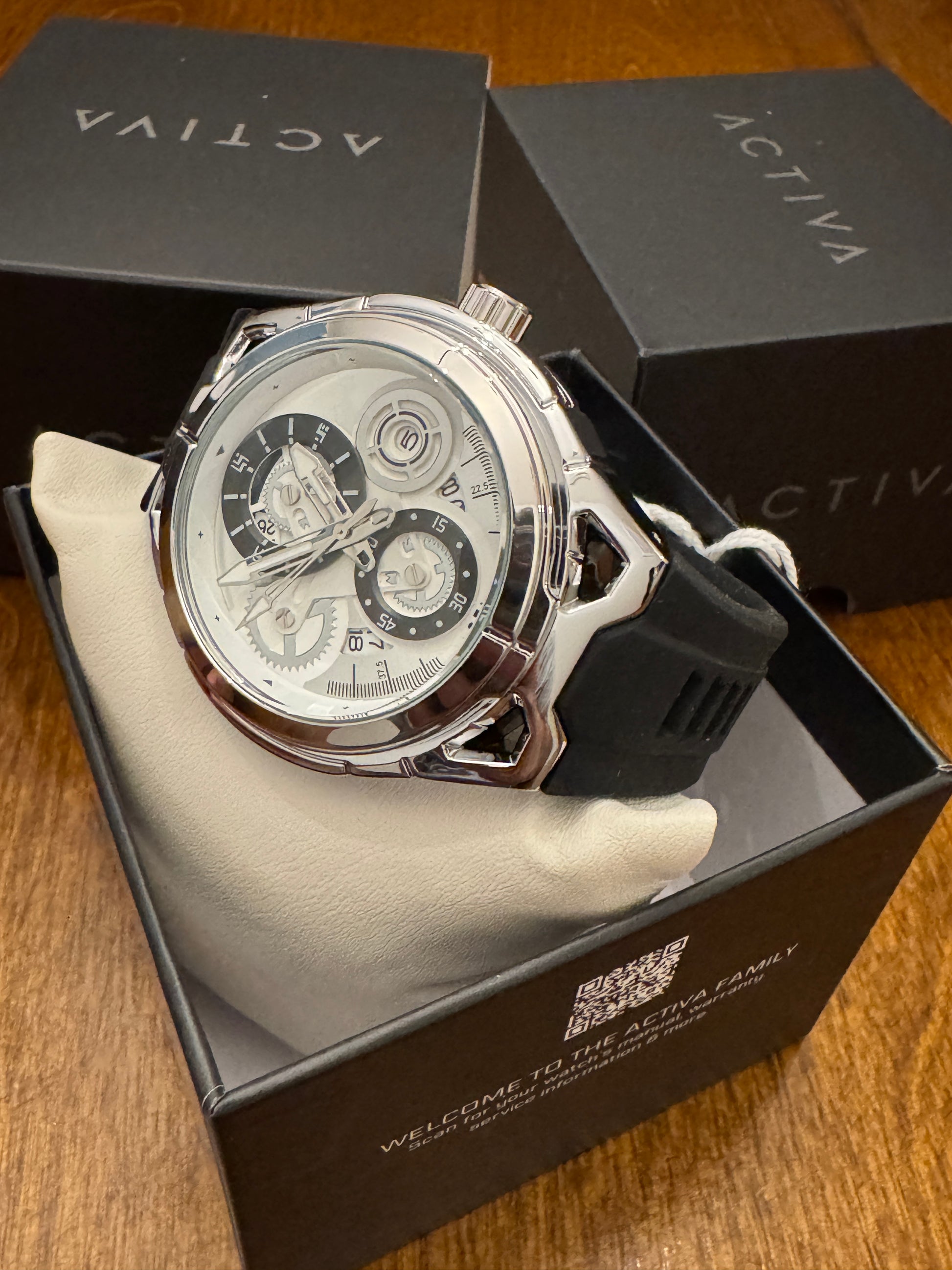 Luxury watch with intricate design on a wooden surface, featuring the brand 'Activa'.